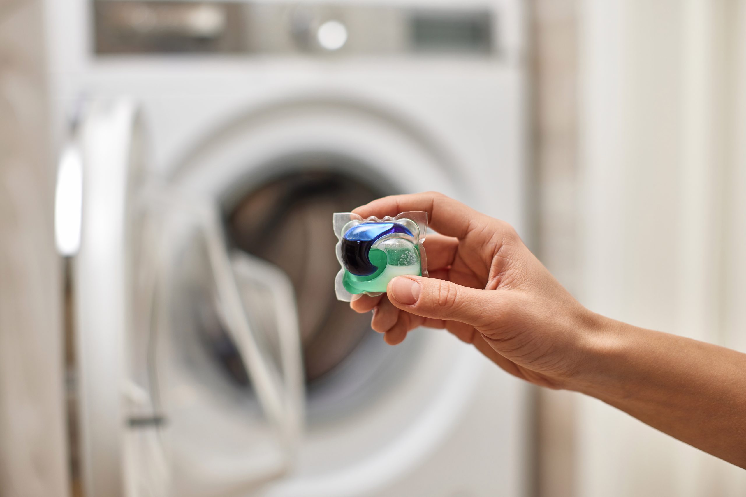 Detergent pod in front of washing machine